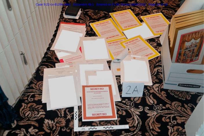 This image contained in a court filing by the Department of Justice on Aug. 30, and redacted by in part by the FBI, shows a photo of documents seized during the Aug. 8 search by the FBI of former President Donald Trump's Mar-a-Lago estate in Florida.